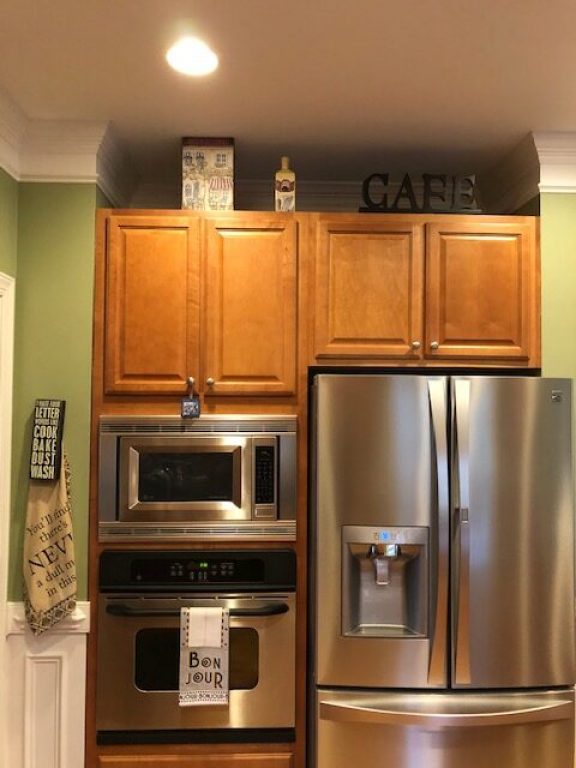 Kitchen with outdated cabinets and cramped design